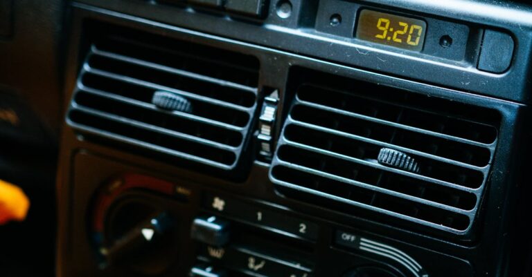 Detailed view of a car dashboard with electronic controls and digital clock.